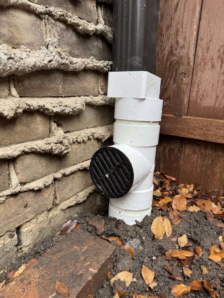 Gutter downspouts tied in to underground drainage system