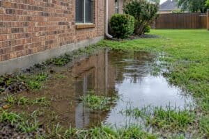 Water pooling next to house Dallas Drainage Pros
